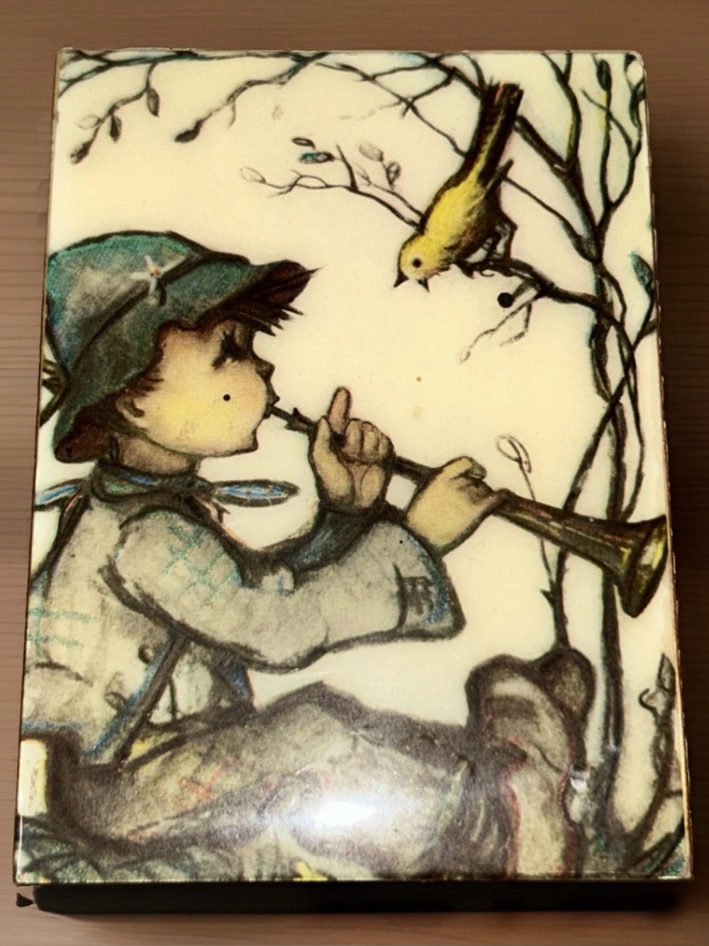 vintage Hummel musical trinket box with boy playing a flute for a yellow bird